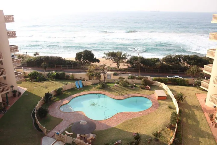 View from the apartment over the pool and beach
