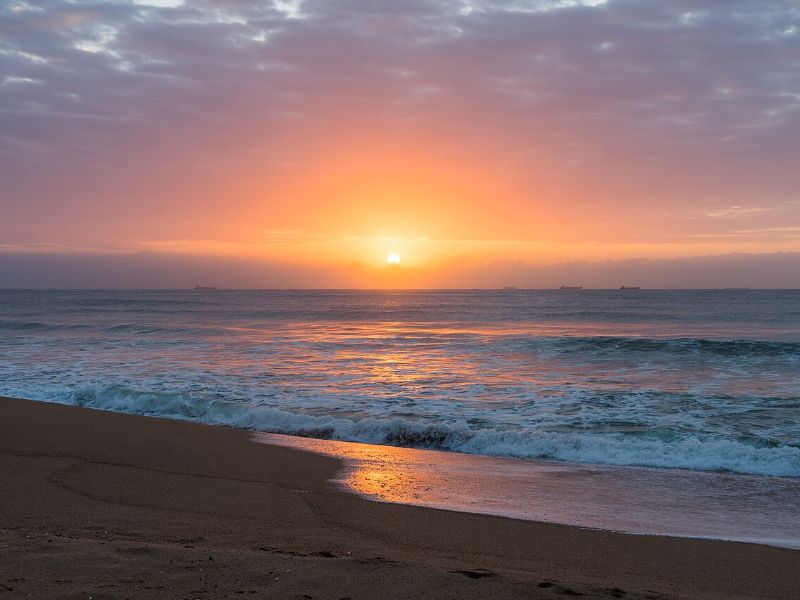Sunrise over the Indian Ocean on the sand between Umdloti and Umhlanga