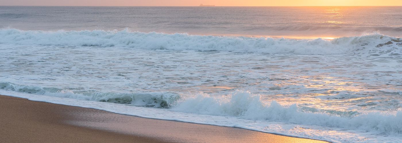 Sunrise over a long North Coast beach